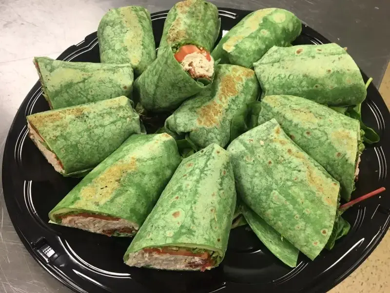 Spinach wraps cut into pinwheels on a platter