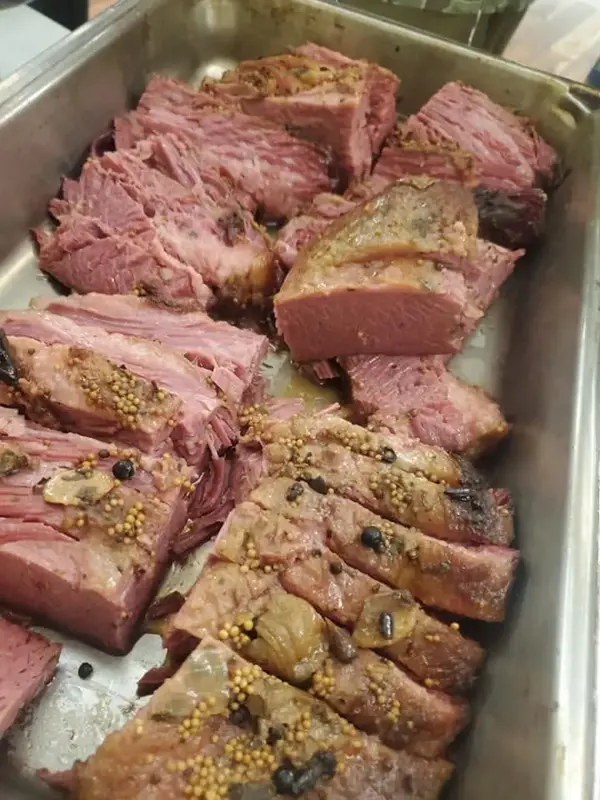Sliced roasted meat on a catering tray