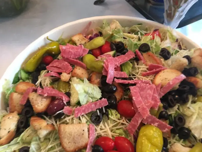 Colorful salad with sliced meats, vegetables and berries