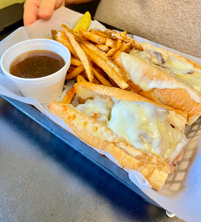 Hot sandwich with fries and a cup of au jus