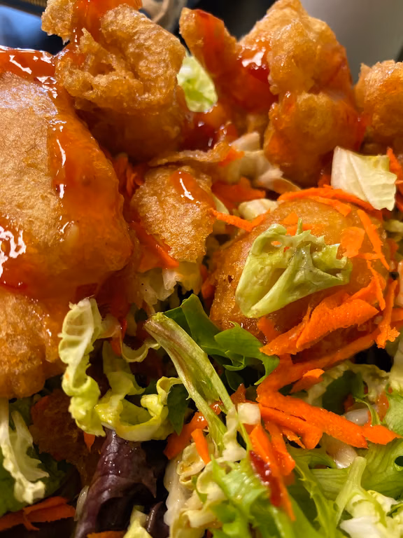 Fried bites served over a fresh salad