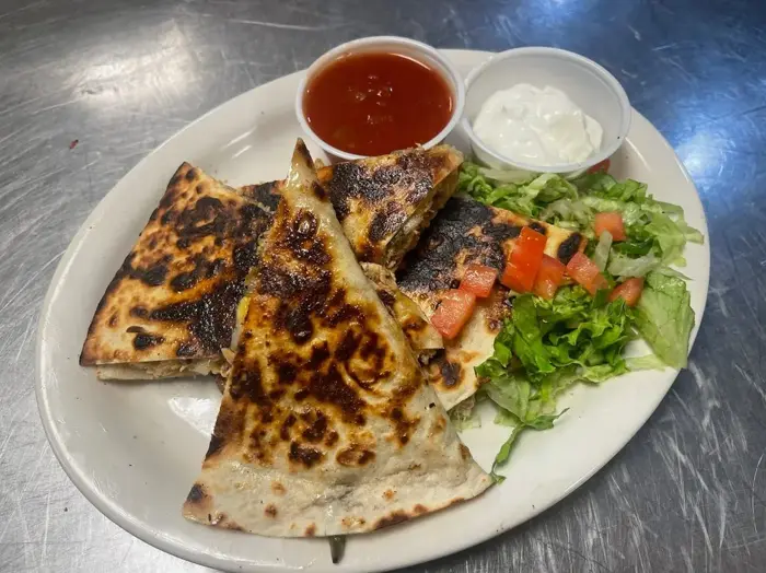 Grilled quesadilla wedges with salsa, sour cream and a side salad